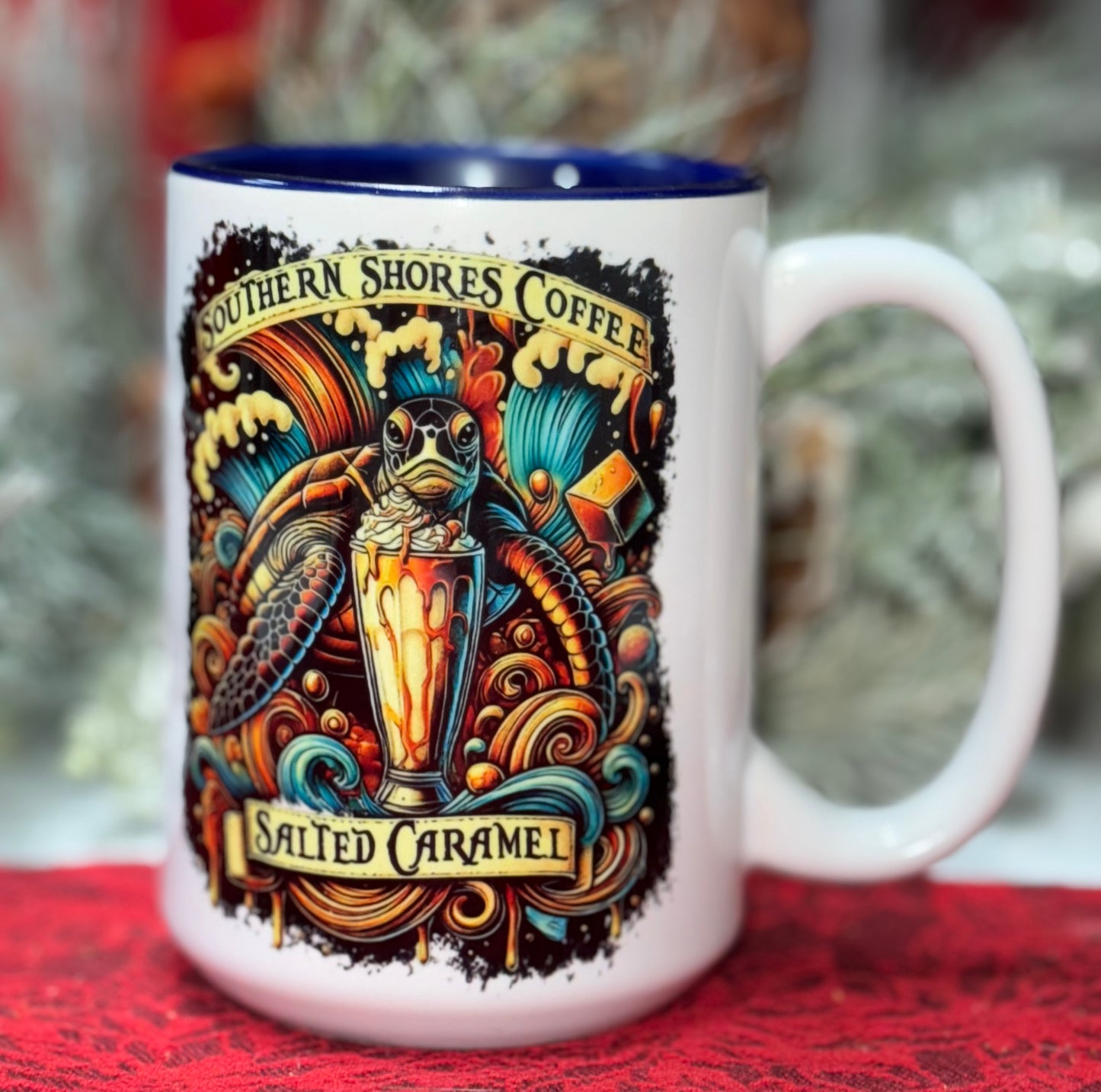 A coffee mug with a sea turtle enjoying a salted caramel frappe whit a background of colorful waves and Southern Shores Coffee around the image.