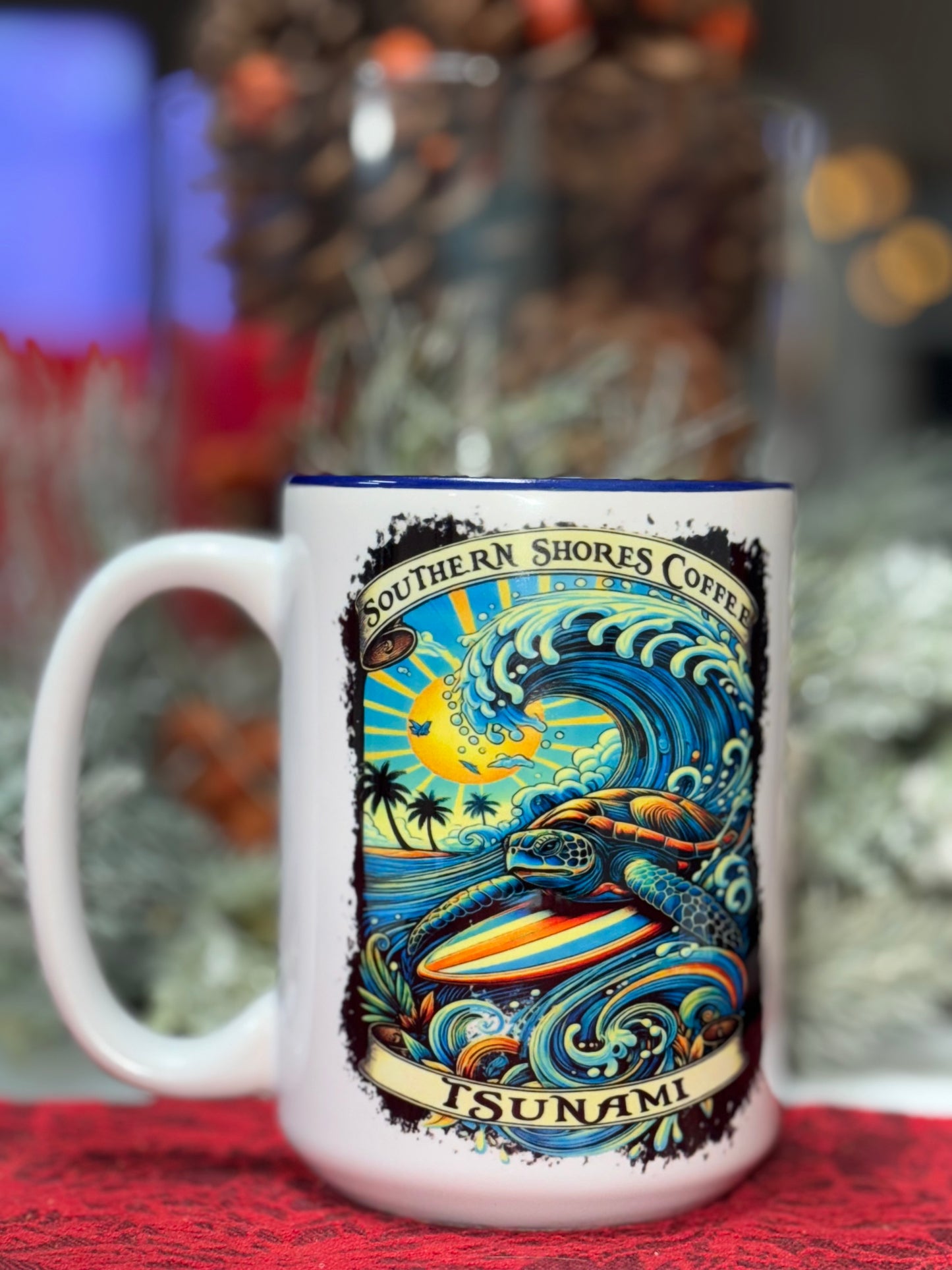 A coffee mug with a turtle surfing a wave and southern shores coffee in a banner