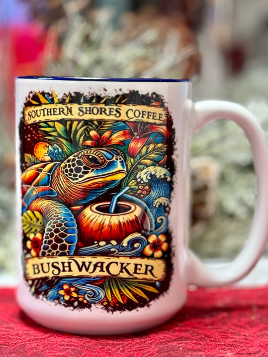 A coffee mug with a sea turtle drinking from a coconut surrounded by tropical flowers and waves.