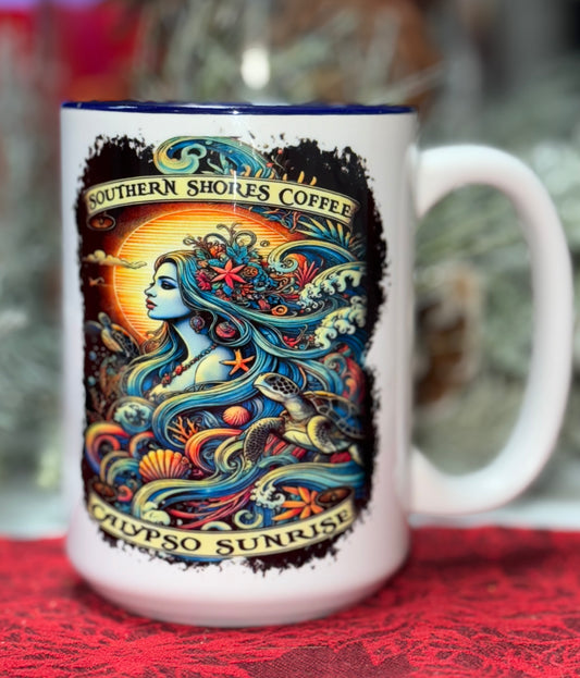 A coffee mug with an image of Calypso surrounded by two sea turtles, waves and sea shells surrounded by Southern Shores coffee logo